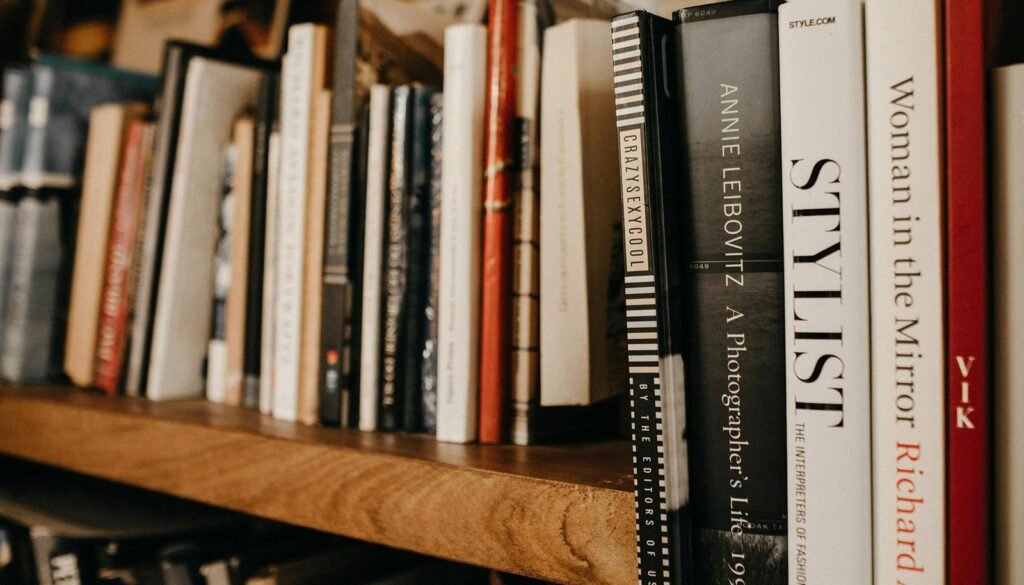 Author analyzing book title performance data with bestselling novels displayed on screen