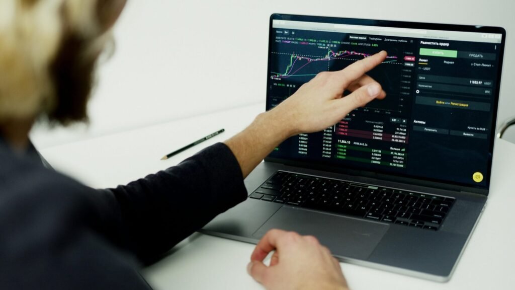 Author analyzing Facebook ad performance on a computer with book marketing dashboard